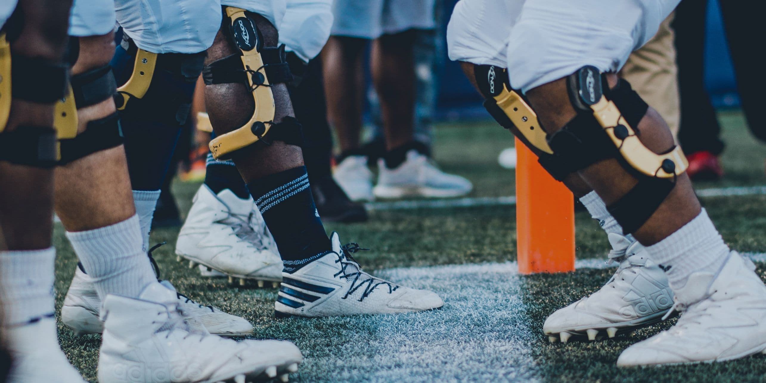 Football linemen lining up on field