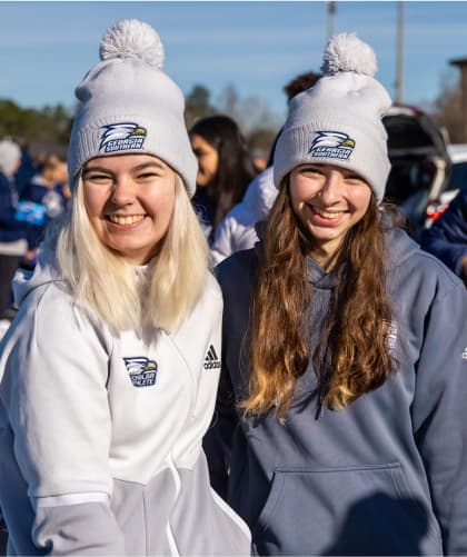 Two Georgia Southern fans wearing matching grey GSU beanies